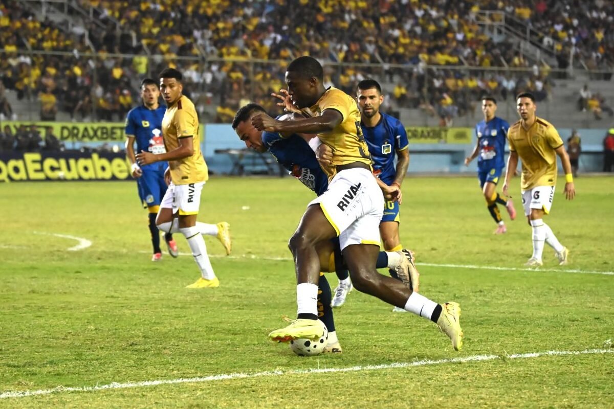Jefferson Wila, de Barcelona SC, disputa el balón con un jugador del Delfín. Foto: API